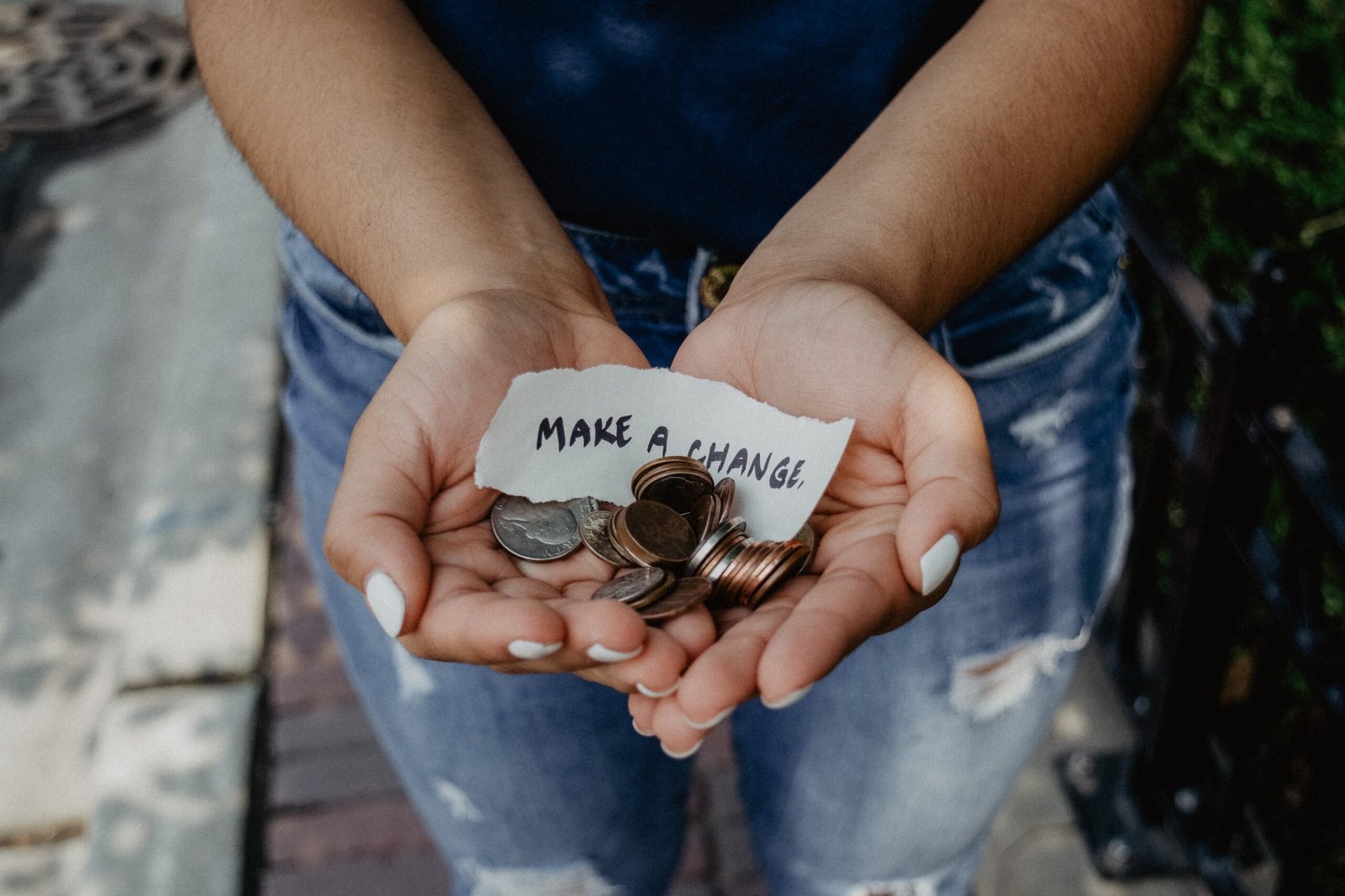 person-showing-both-hands-with-make-a-change-note-and-coins